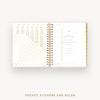 An open spiral-bound planner or pocket organizer shown on a light gray background, with gold foil dot patterns on the left page and a minimalist interior spread labeled 'Day Designer' on the right. Text below reads 'POCKET, STICKERS AND RULER'.