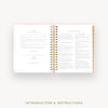 An open spiral-bound instruction booklet or planner showing printed introduction and instructions pages, centered on a light gray background with the text 'INTRODUCTION & INSTRUCTIONS' below.
