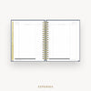 An open spiral-bound planner showing an expenses page with lined columns, gold rings, and a gold vertical tab on the left, centered on a light gray background with the word EXPENSES below.