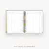 An open spiral-bound planner or notebook showing a gift ideas to remember grid page, photographed on a light gray background with the text 'GIFT IDEAS TO REMEMBER' below.