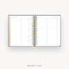 An open spiral-bound bucket list planner shown on a light gray background, with lined pages, a gold wire binding, and a gold vertical tab on the left page. The text 'BUCKET LIST' appears below the product.