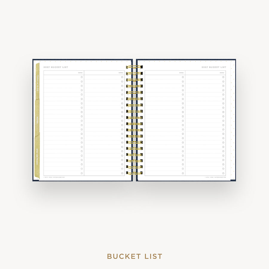 An open spiral-bound bucket list planner shown on a light gray background, with lined pages, a gold wire binding, and a gold vertical tab on the left page. The text 'BUCKET LIST' appears below the product.