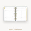 An open spiral-bound weekly planner page with white pages, navy blue binding, and gold accents, shown on a light gray background with the text 'WEEKLY PLANNING PAGE' below.