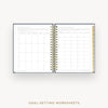 An open spiral-bound planner or workbook showing two pages of goal-setting worksheets, with a gold wire binding and a gold page tab, on a light gray background. Text below reads 'GOAL-SETTING WORKSHEETS'.