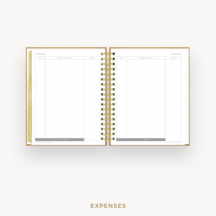 An open spiral-bound planner showing the Expenses page with lined columns, gold-toned binding, and a gold vertical tab on the left, centered on a light gray background with the word EXPENSES below.