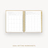 An open spiral-bound planner or notebook showing two pages of goal-setting worksheets, with a gold wire binding and gold-toned page edges, centered on a light gray background. Text below reads 'GOAL-SETTING WORKSHEETS'.