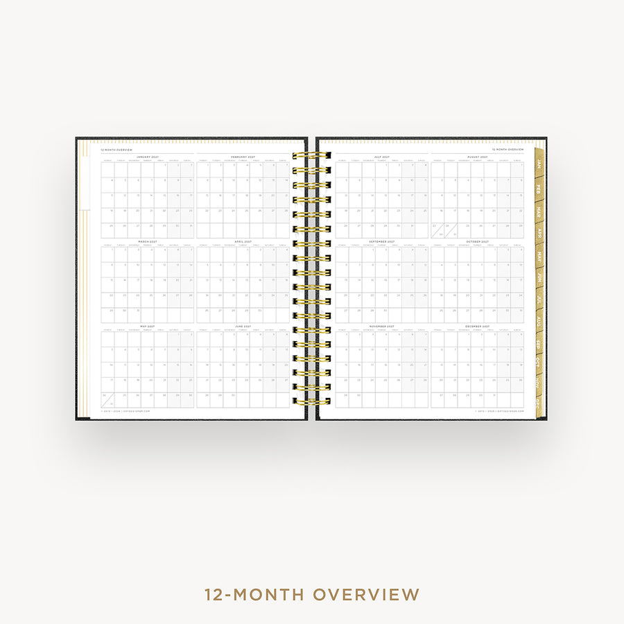 An open spiral-bound planner showing a 12-month overview calendar spread on a light gray background, with the text '12-MONTH OVERVIEW' below.