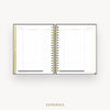 An open spiral-bound planner showing an expenses page with lined columns, gold rings, and a gold vertical tab, centered on a light gray background with the word EXPENSES below.