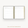 An open spiral-bound planner or notebook showing two printed goal-setting worksheet pages, with a gold wire binding and a gold page accent on the right side, photographed on a light gray background. Text below reads 'GOAL-SETTING WORKSHEETS'.