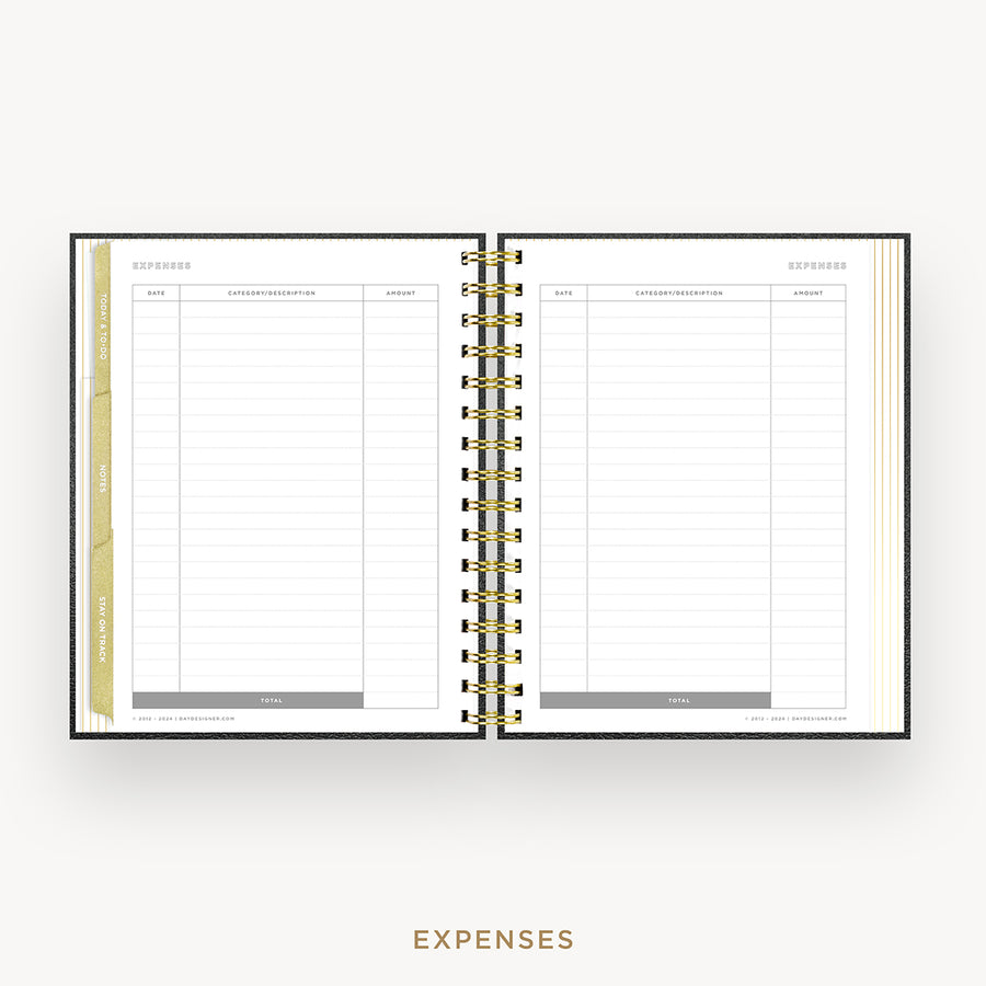 An open spiral-bound planner or notebook showing an expenses page with lined tables and gold-toned ring binding, centered on a light gray background with the word EXPENSES below.