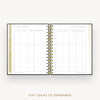 An open spiral-bound planner or notebook showing a gift ideas to remember page spread, with gold-toned binding and a light neutral background. Text below reads 'GIFT IDEAS TO REMEMBER'.