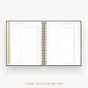 An open spiral-bound thank you note record planner on a light beige background. The pages are white with gold and black text and lines, and the center binding is gold.