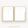 An open spiral-bound planner showing today and to-do pages with gold metallic rings and gold-toned page borders on a light gray background.