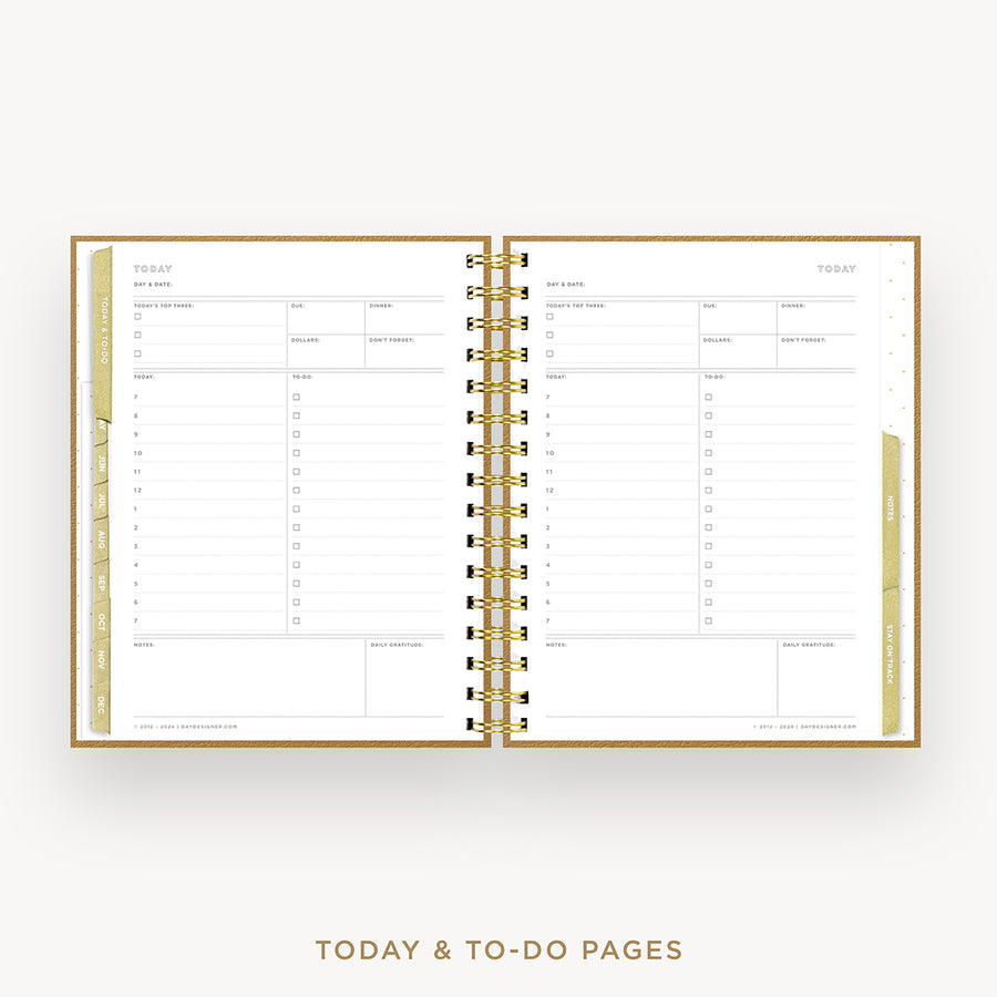 An open spiral-bound planner showing today and to-do pages with gold metallic rings and gold-toned page borders on a light gray background.