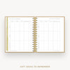 An open spiral-bound gift planner or notebook with gold rings, white pages, and gold-toned tabbing, shown on a light gray background with the text 'GIFT IDEAS TO REMEMBER' below.