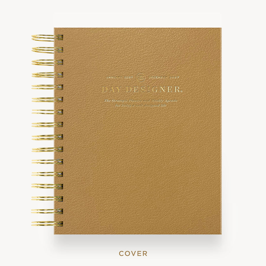 A tan textured spiral notebook with gold wire binding and gold foil lettering on the cover, shown on a clean white background with the word 'COVER' printed below.