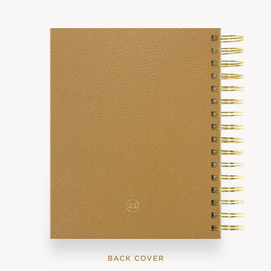 A tan textured spiral notebook shown from the back, featuring a gold-tone spiral binding and a small circular logo near the bottom. The text 'BACK COVER' is printed below the notebook on a clean white background.