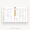 An open spiral-bound planner or notebook showing a packing checklist page spread across both pages, with a pale pink border, gold rings, and a gold vertical tab on the left. The words 'PACKING CHECKLIST' appear below the product on a light gray background.