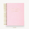 A pink spiral-bound notebook with gold wire binding and gold foil text on the cover, shown on a clean white background with the word 'COVER' below.