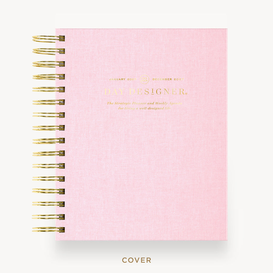 A pink spiral-bound notebook with gold wire binding and gold foil text on the cover, shown on a clean white background with the word 'COVER' below.