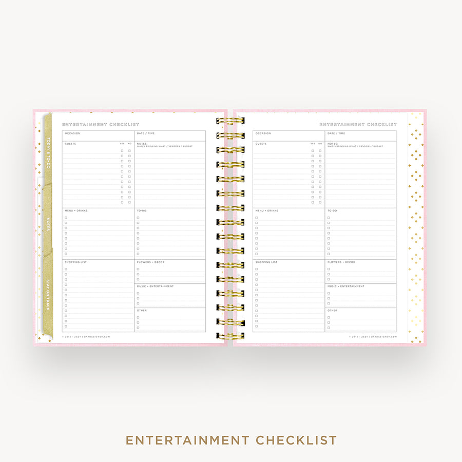An open spiral-bound planner or checklist book showing two printed pages titled 'ENTERTAINMENT CHECKLIST' on a light gray background. The pages are white with fine pink border lines, small gold confetti dots, and gold-and-white spiral binding.