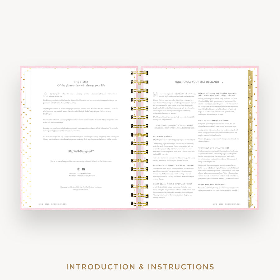 An open spiral-bound booklet or planner showing printed introduction and instructions pages, with a pink border, gold foil accents, and a light neutral background. The text at the bottom reads 'INTRODUCTION & INSTRUCTIONS'.