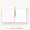 An open spiral-bound workbook showing self-assessment worksheet pages with tables and a Venn diagram, presented on a light neutral background with the text 'SELF-ASSESSMENT WORKSHEETS' below.