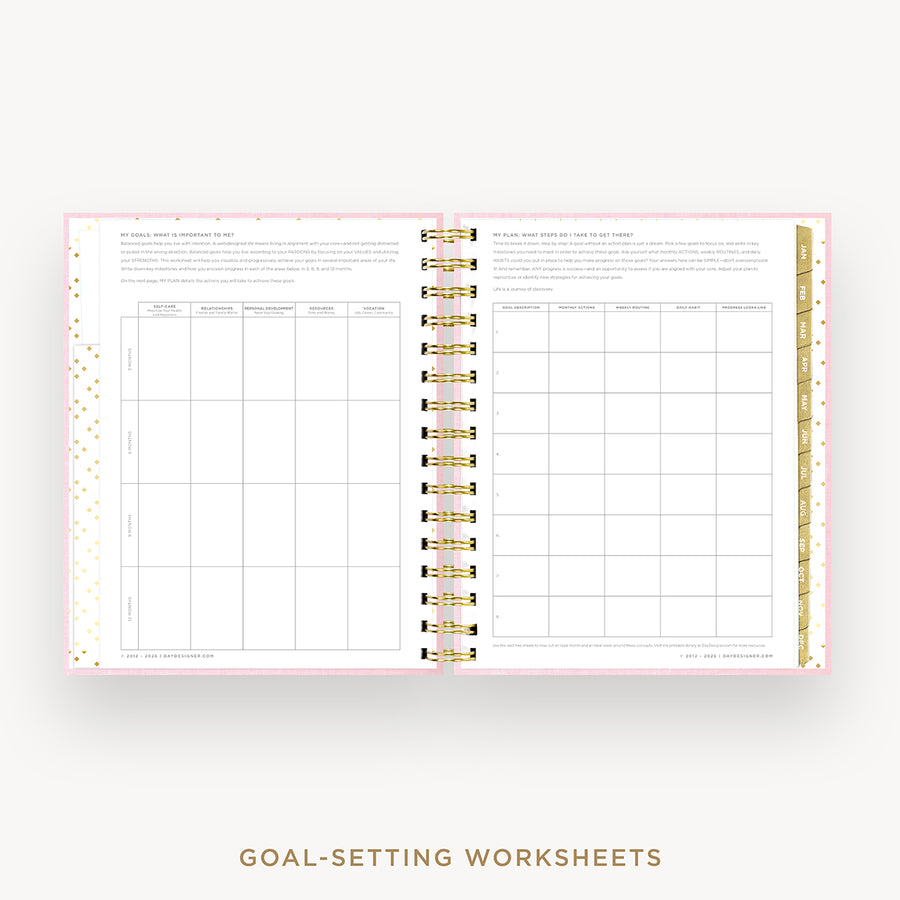 An open spiral-bound planner or notebook showing two pages of goal-setting worksheets with pink borders, gold polka dots, and gold ring binding, on a light gray background with the text 'GOAL-SETTING WORKSHEETS' below.