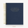 A navy blue spiral-bound planner cover with gold wire binding and gold text reading 'DAY DESIGNER' on a clean white background.