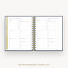 An open spiral-bound checklist planner showing two inner pages titled 'ENTERTAINMENT CHECKLIST' with lined sections and tabs, photographed on a light gray background with the text 'ENTERTAINMENT CHECKLIST' below.