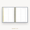 An open spiral-bound bucket list planner or notebook on a light gray background, with lined checklist pages and gold-toned ring binding. The text 'BUCKET LIST' appears below the product.