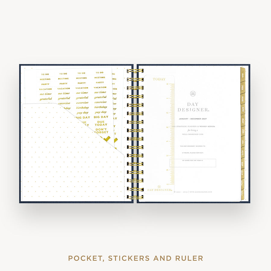 An open spiral-bound planner or pocket organizer shown on a light gray background, with gold foil text and divider pages inside. The bottom text reads 'POCKET, STICKERS AND RULER'.