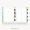 An open spiral-bound planner or notebook showing the 'Favorites List' interior page layout. The pages are white with light blue-gray columns and checkboxes, bound with metallic gold rings, and photographed on a light gray background with the text 'FAVORITES LIST' below.