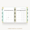 An open tabbed monthly calendar planner shown from above on a light gray background. The pages are white with gold spiral binding and a mint green left tab.