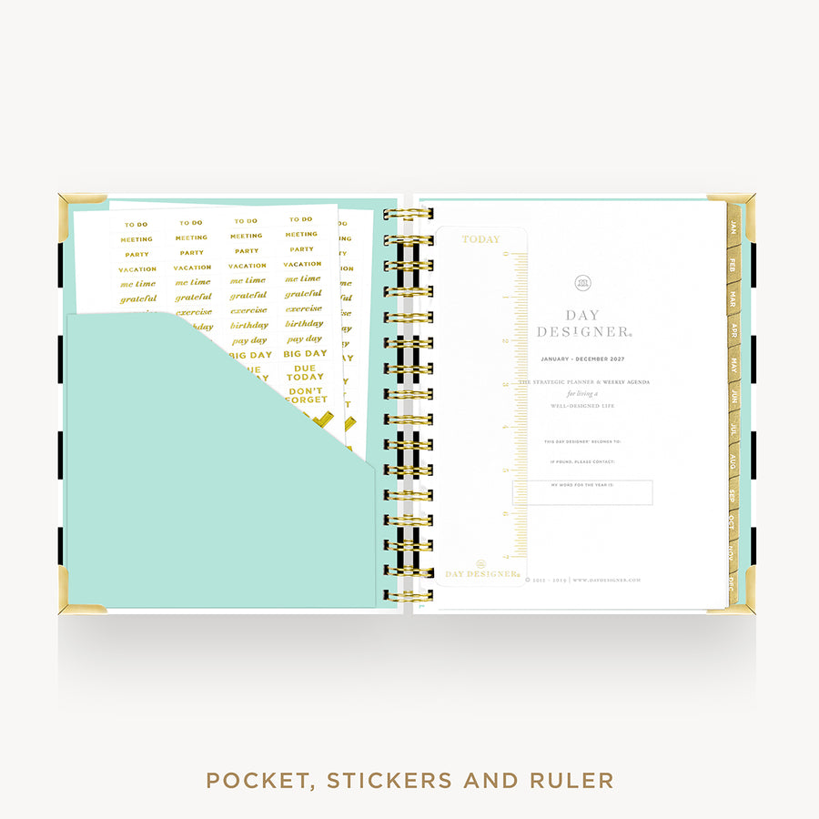 An open pocket planner with gold-tone spiral rings, white pages, a mint pocket, and gold text accents. The text below reads 'POCKET, STICKERS AND RULER'.