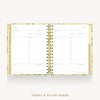 An open spiral-bound planner or agenda showing today's and to-do pages, with a gold-toned floral-patterned cover and gold wire binding on a light gray background.
