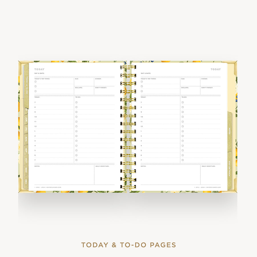 An open spiral-bound planner or agenda showing today's and to-do pages, with a gold-toned floral-patterned cover and gold wire binding on a light gray background.