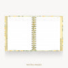 An open spiral-bound planner or notebook with lined white pages, a gold-toned center spiral, and a floral-patterned gold border, shown on a light gray background with the text 'NOTES PAGES' below.