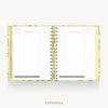 An open spiral-bound planner or notebook showing lined expense pages on both sides, with a floral-patterned cover and gold-toned rings, centered on a light gray background with the word EXPENSES below.