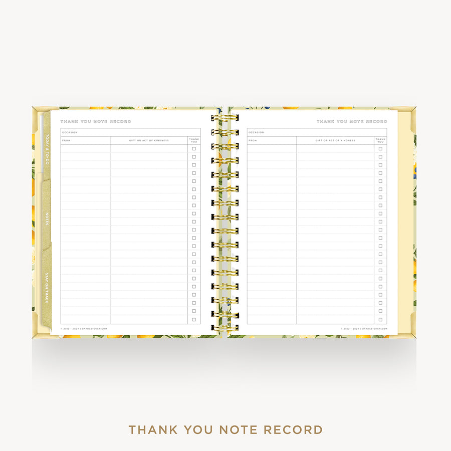 An open spiral-bound thank you note record planner with a gold wire coil and a yellow floral patterned cover, shown on a light gray background with the text 'THANK YOU NOTE RECORD' below.