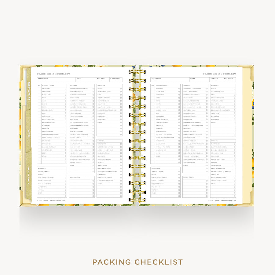 An open spiral-bound planner or notebook showing a packing checklist page spread across both sides, with a gold-toned spiral and a light floral-patterned cover on a white background.