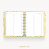 An open spiral-bound planner or budget tracker with lined pages titled 'BEST BUCKET LIST' and a floral gold border, shown on a light gray background with the words 'BUCKET LIST' below.