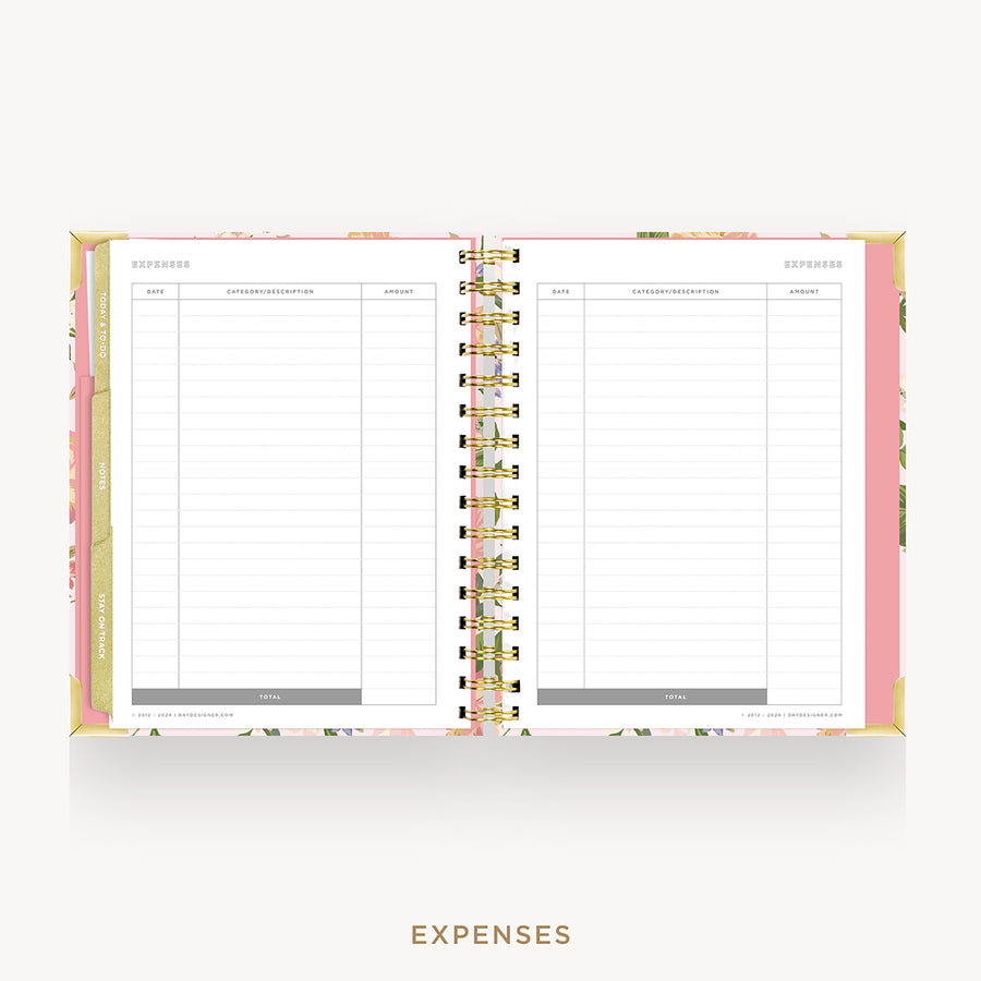 An open spiral-bound planner or notebook showing the expenses page with lined columns, floral-patterned pink and gold covers, and the word EXPENSES printed below on a light gray background.
