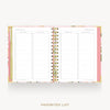 An open spiral-bound planner or agenda showing two 'Favorites List' pages with lined checkboxes, framed by a pink cover and floral-patterned edges, on a light gray background with the text 'FAVORITES LIST' below.