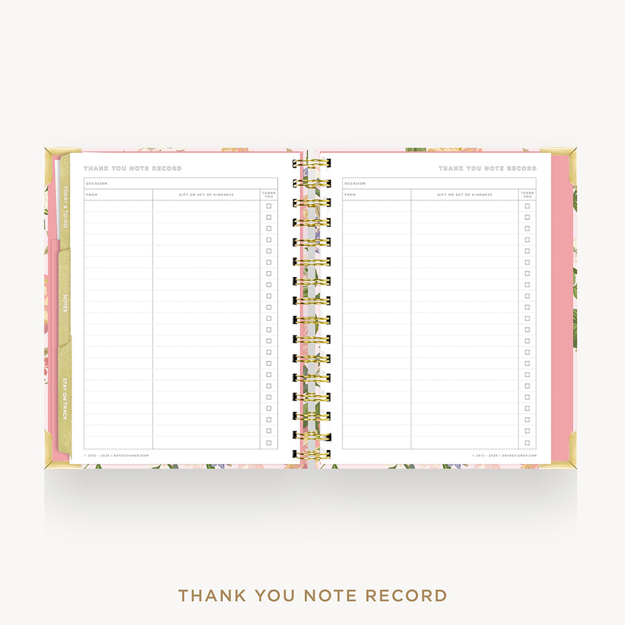 An open spiral-bound thank you note record planner on a light gray background. The pages are lined with a clean white layout, and the floral-patterned cover and gold wire binding are visible.