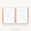 An open spiral-bound planner or notebook showing two printed checklist pages titled 'Packing Checklist' and 'Packing Schedule,' with a pink cover and floral border on a light gray background.