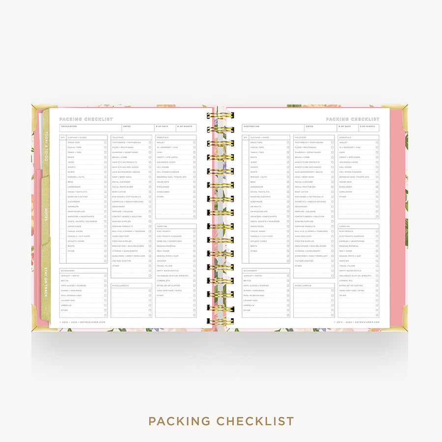 An open spiral-bound planner or notebook showing two printed checklist pages titled 'Packing Checklist' and 'Packing Schedule,' with a pink cover and floral border on a light gray background.