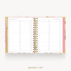 An open spiral-bound planner or notebook with a floral pink cover and lined pages labeled '2027 BUCKET LIST,' shown on a light gray background with the words 'BUCKET LIST' below.