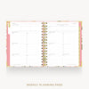 An open spiral-bound weekly planner page set displayed on a light gray background, with floral pink and gold accents and the text 'WEEKLY PLANNING PAGE' below.