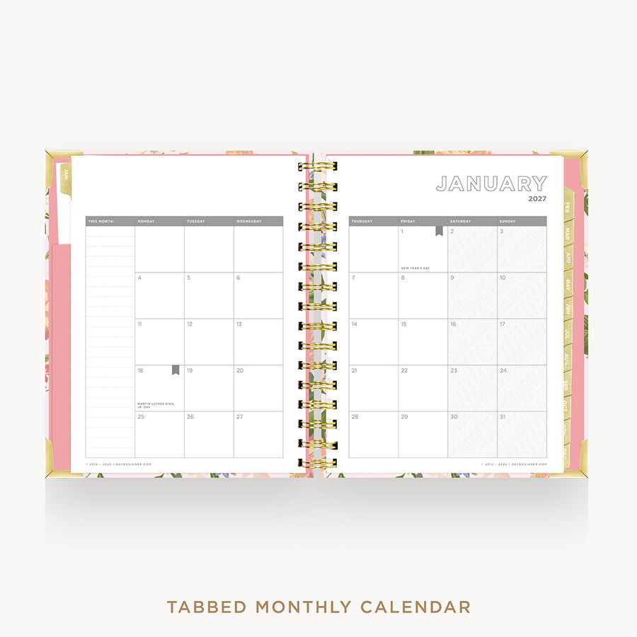 An open monthly calendar planner with two visible pages showing January 2027, bound by gold-tone wire loops. The cover has a pink base with floral accents, and the text 'TABBED MONTHLY CALENDAR' appears below on a light gray background.